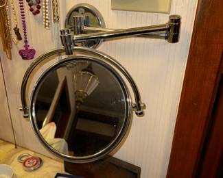 Wall mounted, swing arm, double sided, non lighted makeup mirror! Whew that was a lot!