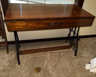 Repurposed sewing machine ends table