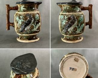 Antique American majolica pitcher with pewter top, raised eagle resting on leafy branch, glazed in mottled medium brown and turquoise background, white trim with brown branch handle