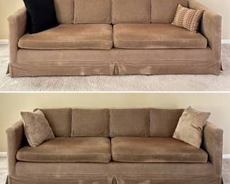 A pair of taupe upholstered 4-seater couches, shown with decorative throw pillows 