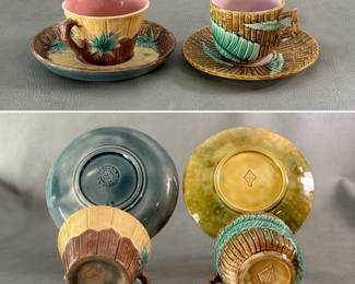 An antique late 19th century Etruscan Majolica Bamboo teacup and saucer set by American potter Griffin, Smith & Hill, Phoenixville, PA, features a raised, sculptural bamboo texture with green leaf motifs against yellow and brown tones, pink liner, impressed GSH Etruscan mark on saucer; and an antique English majolica teacup and saucer set in a hand-painted bamboo and fern pattern, cup with pink liner; both w/impressed England registration mark. 