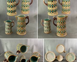 A group of 4 antique Wedgwood majolica steins or pitchers known as “caterers jug,” the body moulded with three bands oval forms in turquoise and brown between three yellow bands with lines from Shakespeare’s Comedy of Errors “What tho my gates be poor, Take them in good part, Better cheer may you have, but not with better heart” in raised black letters. Sizes 9-1/2", 8-5/8", 7-1/2", 5-1/2", impressed Wedgwood marks, date codes for 1868, 1869, 1870, 1872.