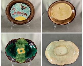Antique English majolica oval shape bread tray in bird and flowers design, raised bird of grey, deep pink, yellow and blue with raised pink flowering brown branch on turquoise and yellow ground, turned up brown edging, 12-1/2" x 11-3/4", incised English Registry mark for 1876-79; and a Wedgwood majolica richly hand-colored/glazed fruit tray known as the Leafage design, molded design of four large green leaves surrounding a yellow center, background in cobalt blue/brown basket design, cream backplate, 11” x 8-3/4", impressed Wedgwood mark, letter date code YCD (1874).