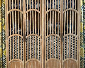 A pair of two-door wooden cabinets featuring decorative faux bamboo and a light wood finish.