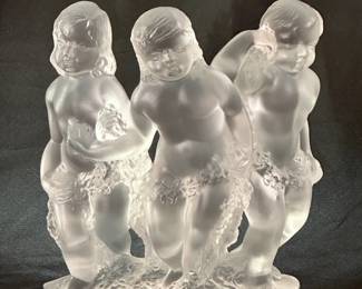 Another view of the signed Lalique France "Luxembourg" crystal figurine featuring three frosted cherubs, also known as putti, holding garlands.