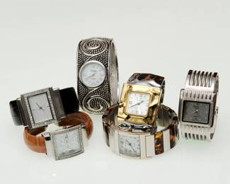 Stylish vintage wrist watches from a collection, including a Vivani silver-tone quartz women's bangle watch with decorative textured cuff band,  a Cannes brand watch with a quartz movement, crystal-encrusted bezel, and a brown leather strap; a Donna Vivian brand timepiece featuring a quartz movement and a polished bangle cuff design, and a Chico's silver/black leather Inspirational Dial bangle bracelet women's watch. 