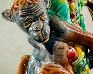 Closeup view of the charming antique majolica figural pitcher, 8-3/4 inches high, molded figure of a monkey with hands behind his back, bright glazed/hand-painted, body in shades of gray and brown, molded green leaves on his back w/shading of yellow and red, liner of deep pink; circa 1880-90, American, no identifying potter marks. 