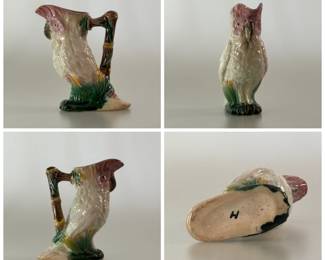 Antique majolica cream pitcher circa 1880-90, American, possibly Morely & Co., figural creamer of hand-painted white cockatoo with lavender comb, eyes and liner; a brown bamboo-form handle with green leaves at base; underglaze black painted letter "H" on the base.
