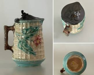 Antique majolica syrup pitcher circa 1880-1890, height 4-1/2", hand-painted/glazed in the wild rose pattern w/pewter lid, pink rose with turquoise leaves and edging, w/raised waffle cream background, brown branch handle, yellow #1 underglaze to base.