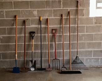 Garden tools including hoes, shovel, edgers, pitchfork, rake, push broom