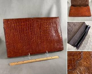 A vintage large brown crocodile skin clutch bag, snap closure, with three inner compartments, one zippered.