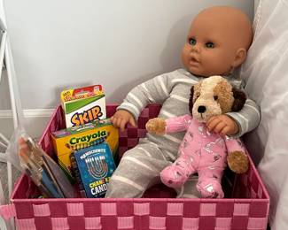 Children's toys including dolls, crayons, paint brushes, stuffed dog, Skip-Bo card game in box