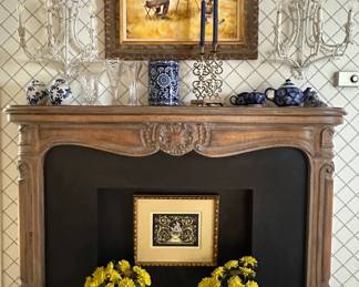 A vintage carved wood fireplace mantel and surround