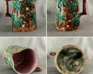 An antique American majolica large size pitcher by Griffin, Hill & Smith, rustic design in mottled brown glaze with raised green ivy leaves and brown branch handle, pink lavender liner, 8-1/4" H. Impressed double circle trademark Etruscan Majolica G H S, impressed catalog #E2