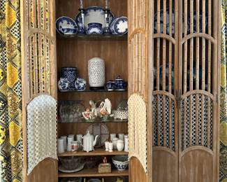 Another view of the pair of two-door wooden cabinets featuring decorative faux bamboo and a light wood finish.