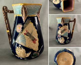 Antique Majolica pitcher circa 1880, English, potter unknown; diamond cut top, dragonfly and fan pattern, hand-painted and glazed with cobalt blue background, lavender liner, white water lily, green leaves and turquoise and deep pink accents, 8-1/2 inches H.