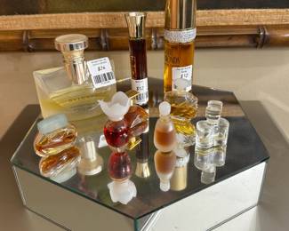 Vintage perfume bottles, some partly full, including Bvlgari Pour Femme Eau de Parfum spray bottle, Estee Lauder Youth Dew bath oil spray, Elizabeth Taylor White Diamonds Eau de Toilette spray, and a collection of miniature decorative vintage perfume bottles