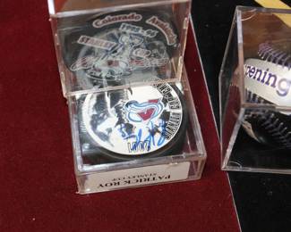 Patrick Roy Signed Stanley Cup Puck as well as '95-'96 Stanley Cup Puck