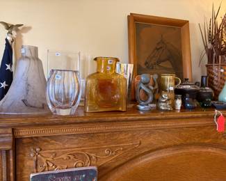 Living room.  Glassware and sculpture on top of vintage upright piano.