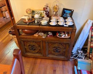 Dining room buffet.  Mova globe.  Clock.  Vintage Chinese carvings.  