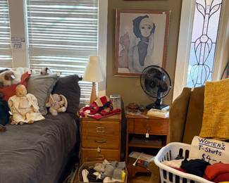 Artwork.  Side tables.  Boxes of women’s clothing.