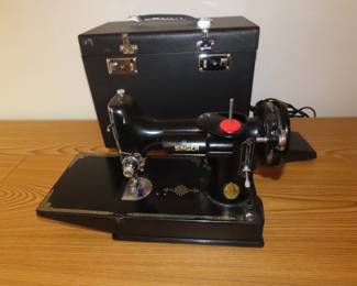 Like new Singer 221 electric sewing machine and case.