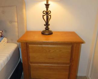 One of two table lamps and three drawer nightstands.