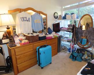 Chest of drawers, luggage, clothing.