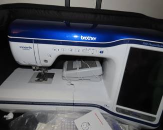 Brother Innovis XV8550D digital embroidery machine with hoops and frames and multiple Floratine embroidery CDs.