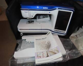 Brother Innovis XV8550D digital embroidery machine with hoops and frames and multiple Floratine embroidery CDs.