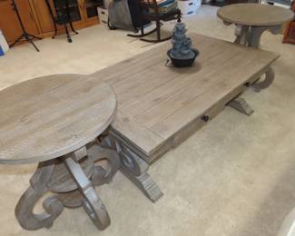 Two round end tables and matching coffee table with drawers.