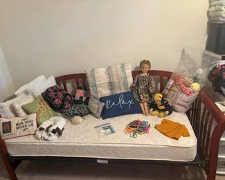 day bed, pillows, dolls