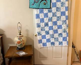 quilts, side table, lamp