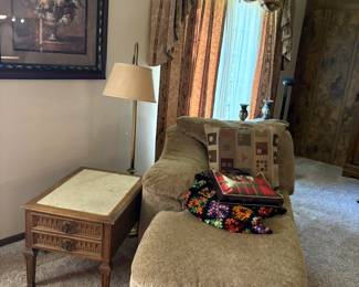 chaise lounge, afghan, side table, lamp, wall decor
