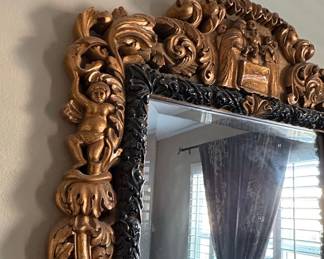 Ornate Giltwood and Black Baroque Mirror with Cherub and Figural Relief