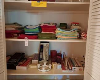 Hall closet full of table candles, table napkins, and more
