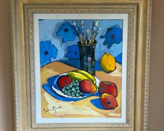 Colorful modern still-life painting by Peruvian artist Yvonne Mora (b. 1959, Lima, Peru) featuring a vibrant arrangement of fruit, grapes, and artist’s brushes rendered in bold expressive brushwork and saturated color. Mora studied painting at the Escuela Nacional de Bellas Artes and exhibited internationally, including solo shows in Lima and Japan during the late 1980s. This lively composition reflects Latin American modernist influence with strong color contrasts and confident palette-knife style application. Presented in an elegant decorative frame, ready to hang and perfect for contemporary, eclectic, or modern interiors. A striking decorative artwork with documented artist biography included.