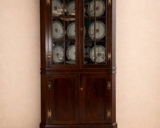 Craftique mahogany corner china cabinet showcasing exceptional American craftsmanship and traditional Colonial Revival design. Known for museum-quality construction and fine hardwoods, Craftique furniture was built for generations. Glass display doors and spacious storage make this an elegant, heirloom-quality dining or display piece.