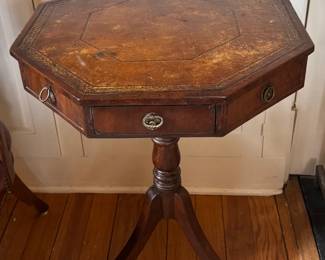 Antique leather inlaid octagonal rent table, original hardware and casters.