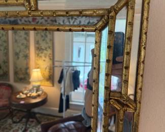 Detail of cushion frame mirror showing gilt faux bamboo