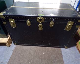 Leather covered travel trunk.