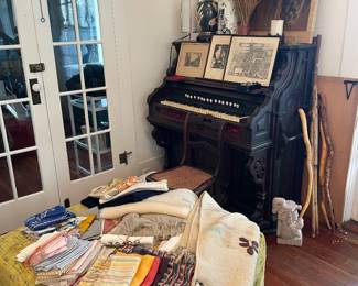 pump organ, walking sticks and canes, oversized ottoman, framed etchings, linens