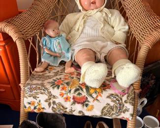Baby doll and wicker rocking chair