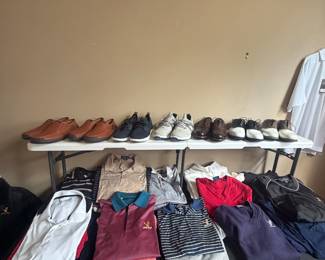 A whole table of monogrammed golden eagle golf shirts. Designer names 