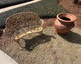 Antique wrought iron and large clay pot on stand 