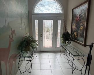 Matching pair of iron and glass consoles