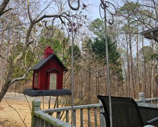 several birdhouses and outdoor hooks