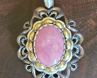 Carolyn Pollack Relios sterling silver pendant featuring a trapezoidal pink gemstone and a central oval mother of pearl cabochon. Rising sun silver border.  