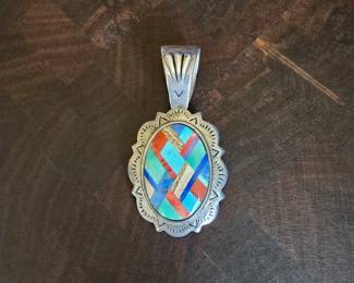 Shube's Manufacturing Inc. sterling silver tribal mosaic inlay with stones such as turquoise, red jasper, rhodonite, and tigers eye.  2.55" long x 1.3" wide.