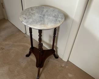 Vintage pedestal stand table features a round marble top. This would make a perfect plant stand!